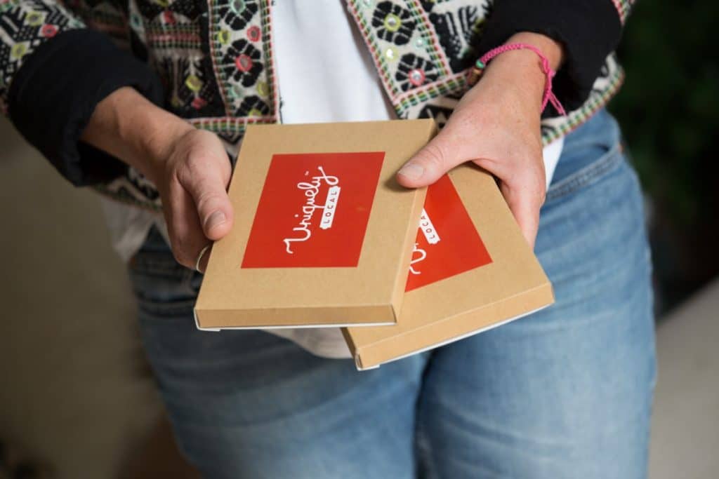 Yorkshire Experience Days and Gift Vouchers - image shows Uniquely Local owner holding two gift voucher boxes