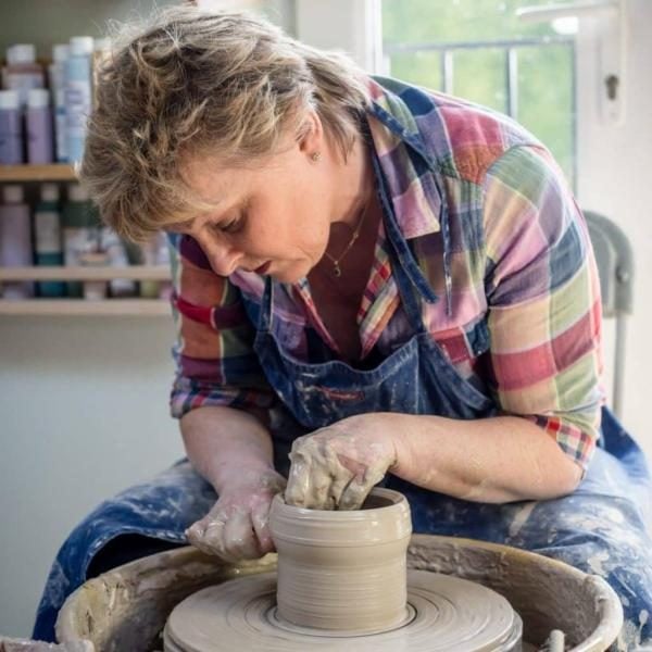 Rachel Byass owner of Fired Art Designs at the pottery wheel