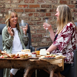 Two People Enjoying a Wine and Cheese Pairing with Love Cheese - Uniquely Local Experiences