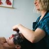 Amy administering a Lift and Glow Facial treatment