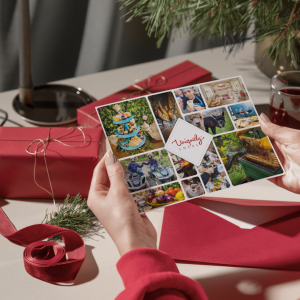 womens hands holding uniquely local experience gift vouchers in a Christmas setting