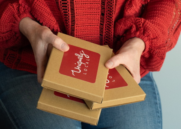 rachel holding new voucher experience gift boxes